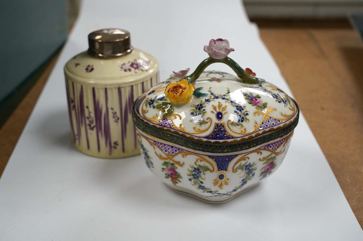 A Dresden porcelain ink stand, 11cm high, and an 18th century English creamware tea caddy with a silver lid, 10cm high. Condition - fair to good